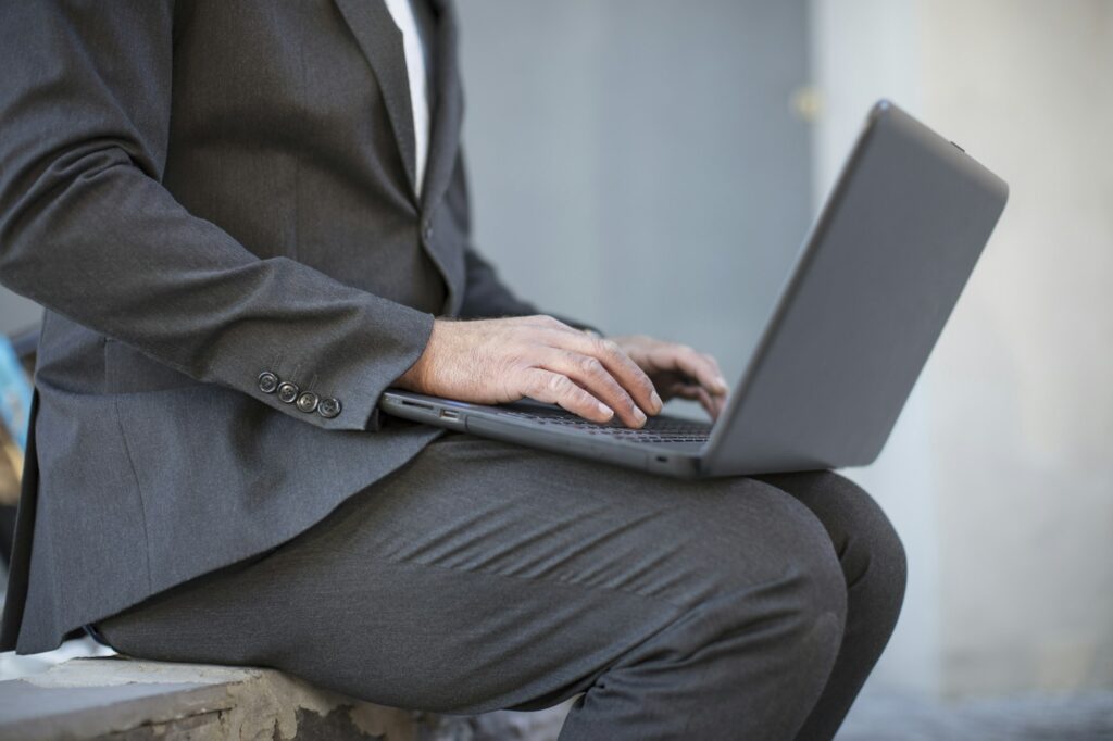 Businessman working on laptop outside