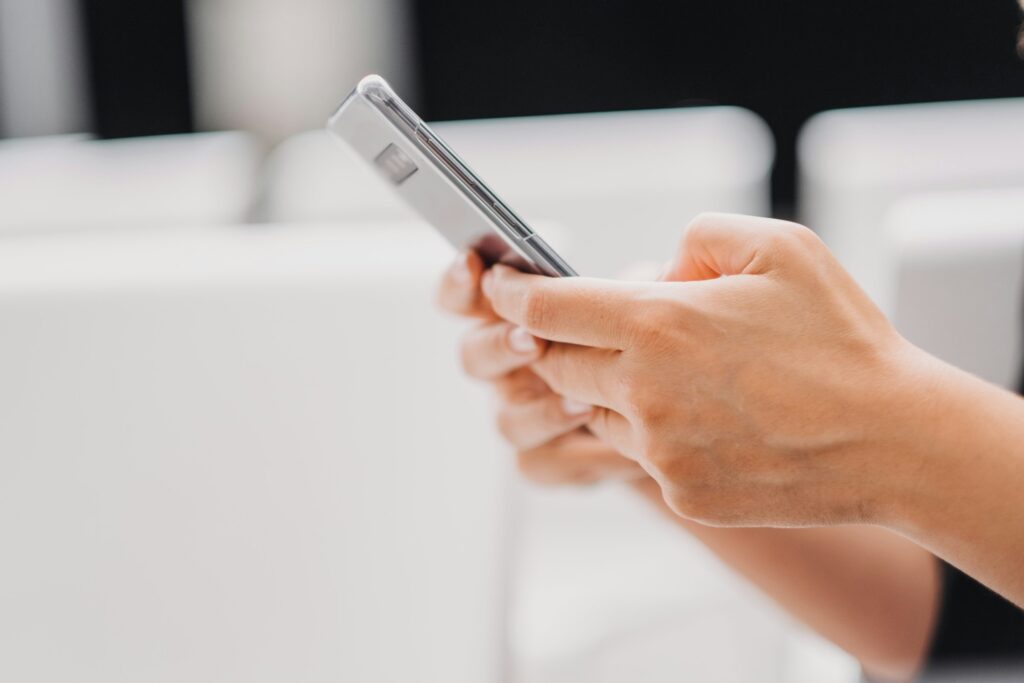 Closeup shot of a person typing on a smart phone