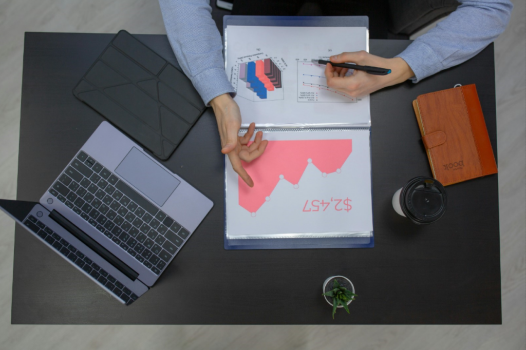 Man working at desk looking at analytics - enlarged