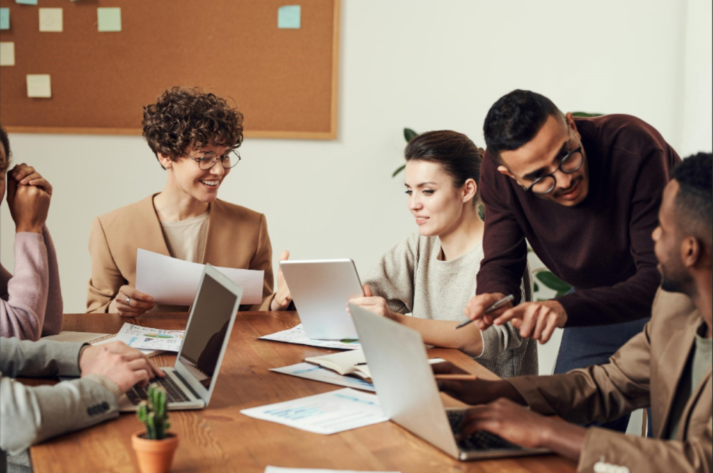 Group collaboratively working at computers - enlarged