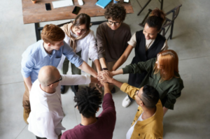 Group putting hands together after a successful meeting - enlarged